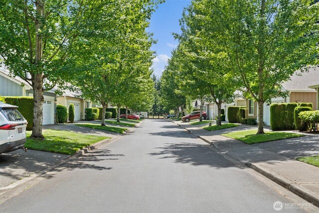 5221 Ivy Hill Ln SE, Lacey, WA 98513 - view of asphalt road with curbs, a residential view, and sidewalks