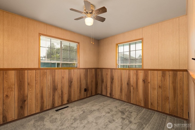 1108 123rd St S, Tacoma, WA 98444 - carpeted spare room with wood walls and ceiling fan