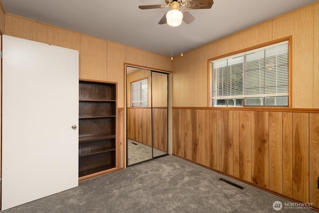 1108 123rd St S, Tacoma, WA 98444 - unfurnished bedroom featuring carpet flooring, wooden walls, and a closet