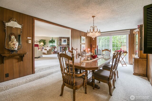 605 Lee Ave, Aberdeen, WA 98520 - carpeted dining area featuring wooden walls, a chandelier, and a textured ceiling