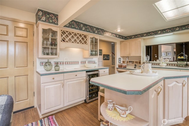 605 Lee Ave, Aberdeen, WA 98520 - kitchen with wine cooler, light countertops, glass insert cabinets, and light wood-type flooring