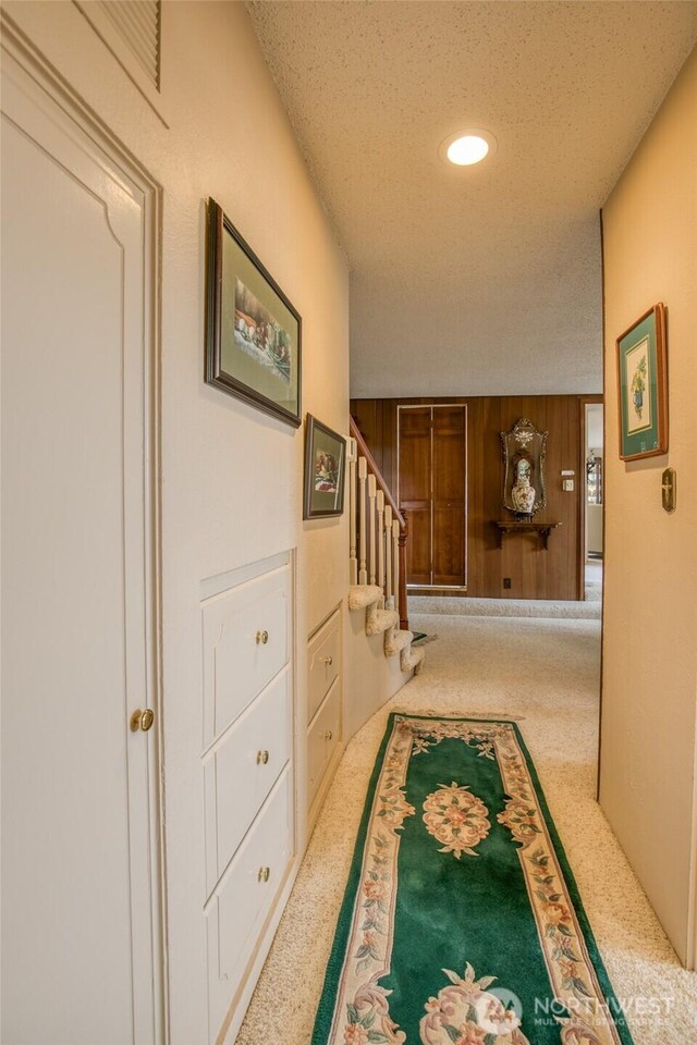 605 Lee Ave, Aberdeen, WA 98520 - hallway with carpet floors, stairs, a textured ceiling, wooden walls, and recessed lighting