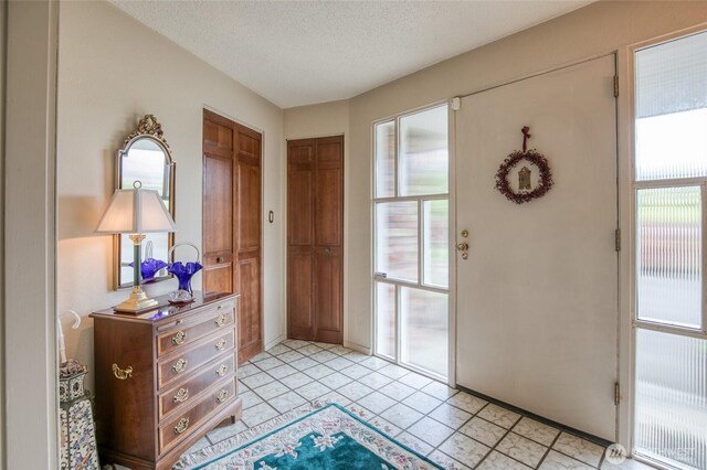 605 Lee Ave, Aberdeen, WA 98520 - foyer entrance with plenty of natural light, a textured ceiling, and light tile patterned floors