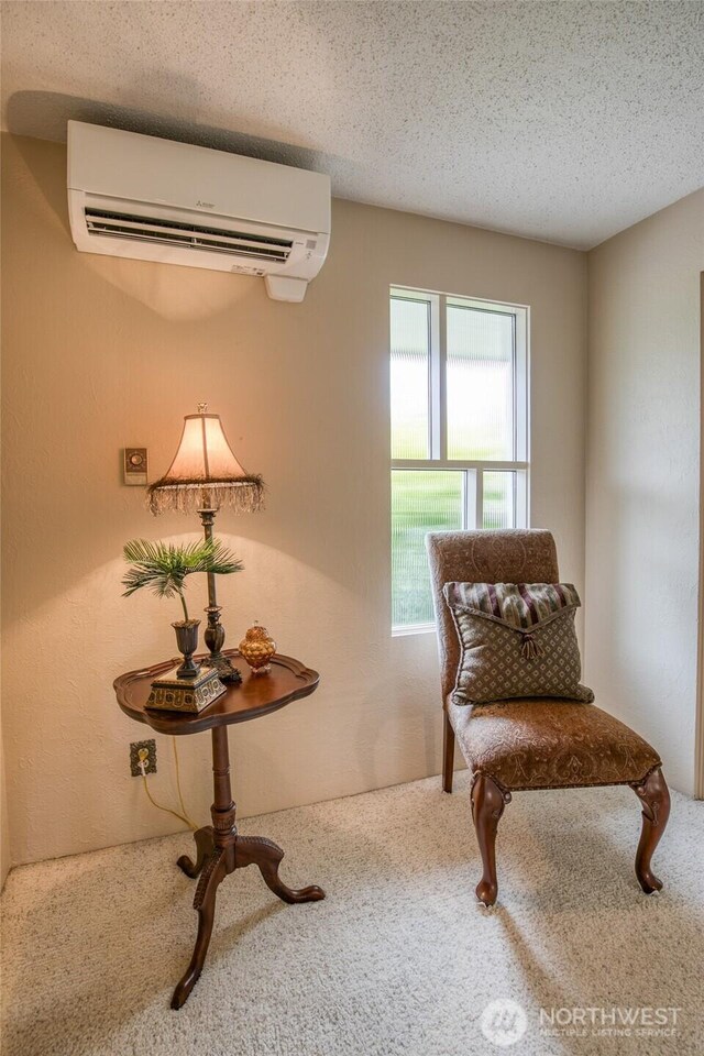 605 Lee Ave, Aberdeen, WA 98520 - sitting room featuring a wall unit AC, carpet flooring, and a textured ceiling