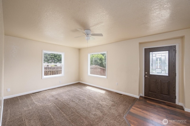 357 7th Ave SW, Ephrata, WA 98823 - foyer featuring ceiling fan, a textured ceiling, plenty of natural light, and dark wood-type flooring