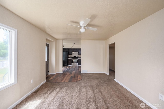 357 7th Ave SW, Ephrata, WA 98823 - unfurnished living room featuring dark carpet and a ceiling fan