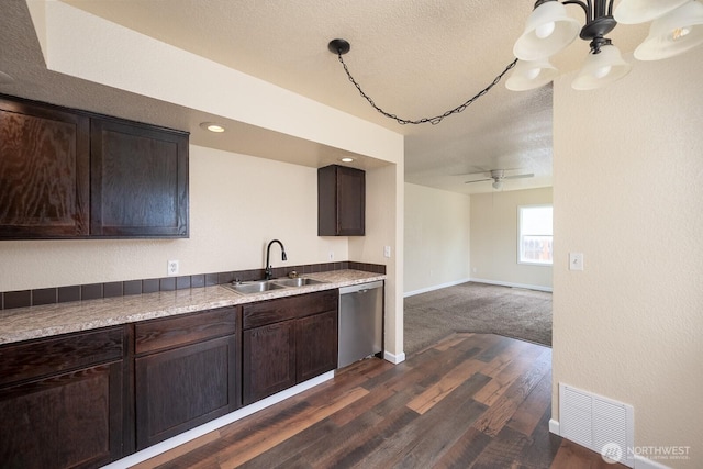 357 7th Ave SW, Ephrata, WA 98823 - kitchen with stainless steel dishwasher, dark brown cabinetry, dark wood finished floors, and a textured ceiling