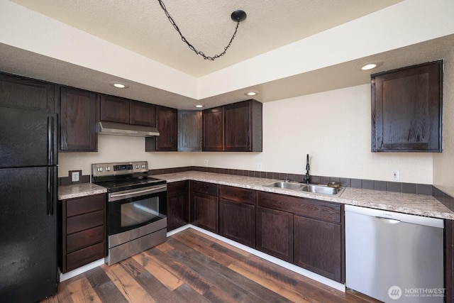 357 7th Ave SW, Ephrata, WA 98823 - kitchen featuring stainless steel appliances, under cabinet range hood, dark brown cabinetry, dark wood-type flooring, and light countertops