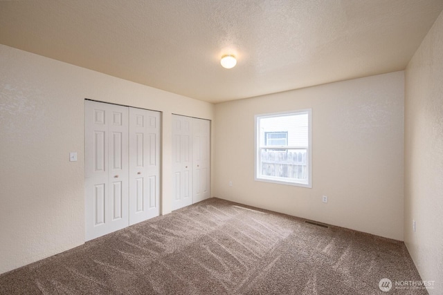 357 7th Ave SW, Ephrata, WA 98823 - unfurnished bedroom with multiple closets and carpet