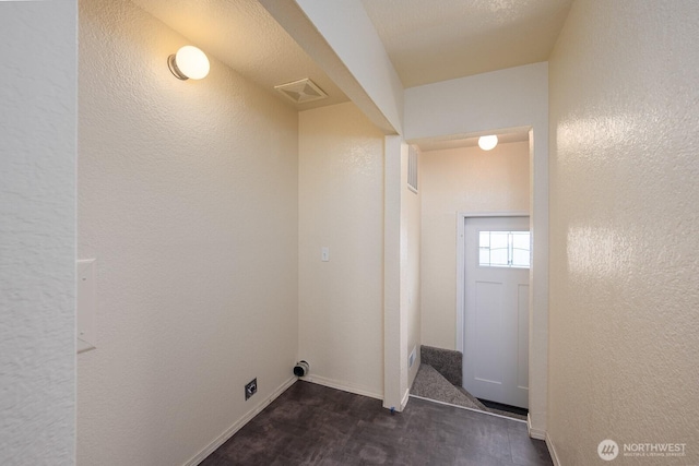 357 7th Ave SW, Ephrata, WA 98823 - laundry area with dark wood finished floors and a textured wall