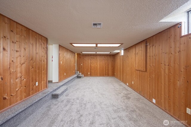 357 7th Ave SW, Ephrata, WA 98823 - carpeted spare room featuring wood walls and a textured ceiling