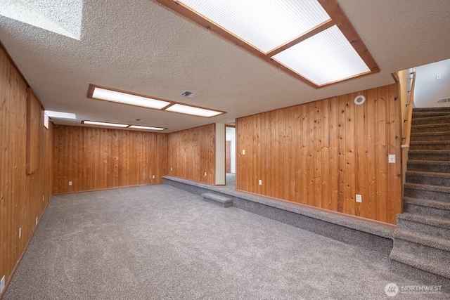357 7th Ave SW, Ephrata, WA 98823 - finished basement featuring stairs, wood walls, carpet flooring, and a textured ceiling