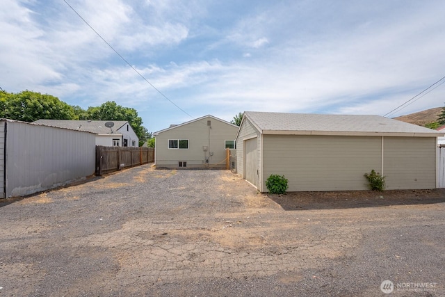 357 7th Ave SW, Ephrata, WA 98823 - back of house with an outdoor structure, a detached garage, and driveway