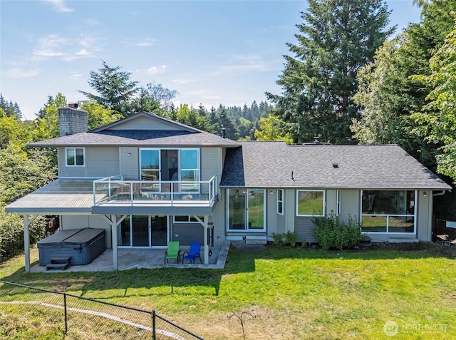 96 Kim Ct, Steilacoom, WA 98388 - back of house with a hot tub, a chimney, a patio, roof with shingles, and a lawn