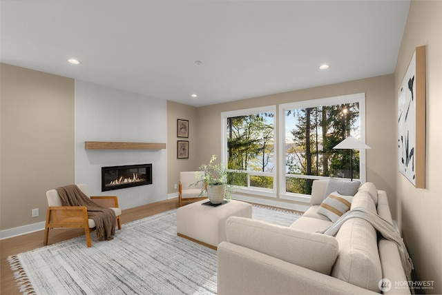 19221 SE 25th St, Sammamish, WA 98075 - living room with a glass covered fireplace, recessed lighting, and wood finished floors