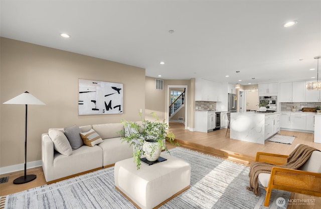 19221 SE 25th St, Sammamish, WA 98075 - living room with recessed lighting, light wood-style flooring, beverage cooler, and stairway