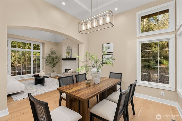 19221 SE 25th St, Sammamish, WA 98075 - dining space with a towering ceiling, light wood-type flooring, a tile fireplace, recessed lighting, and a chandelier