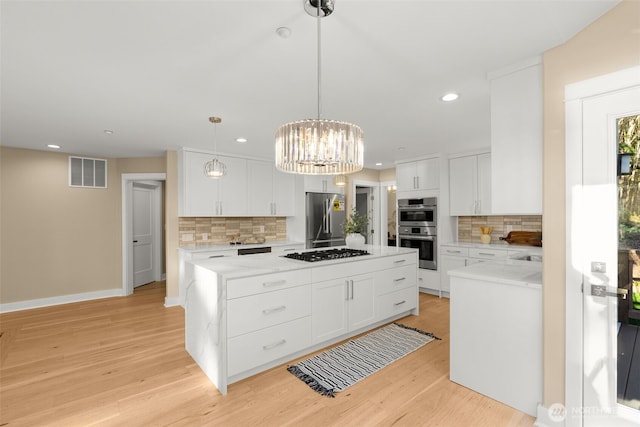 19221 SE 25th St, Sammamish, WA 98075 - kitchen featuring stainless steel appliances, backsplash, a center island, recessed lighting, and light wood finished floors