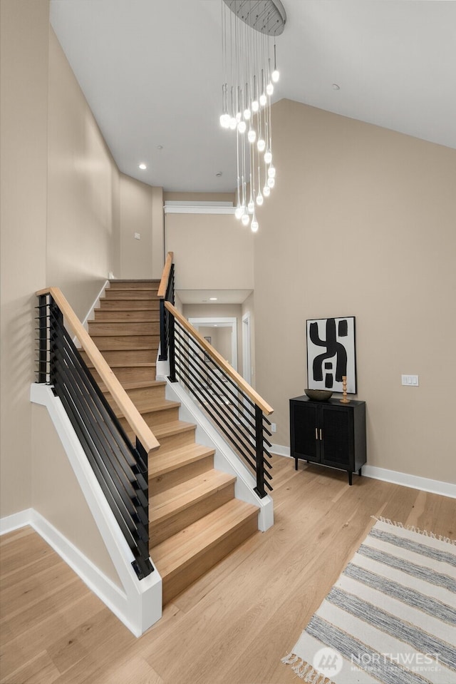 19221 SE 25th St, Sammamish, WA 98075 - staircase featuring wood finished floors and a towering ceiling