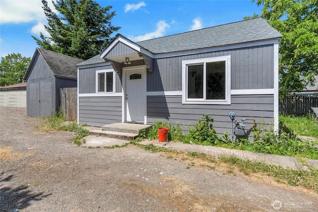 4050 E B St, Tacoma, WA 98404 - bungalow-style home featuring a shingled roof and a storage shed