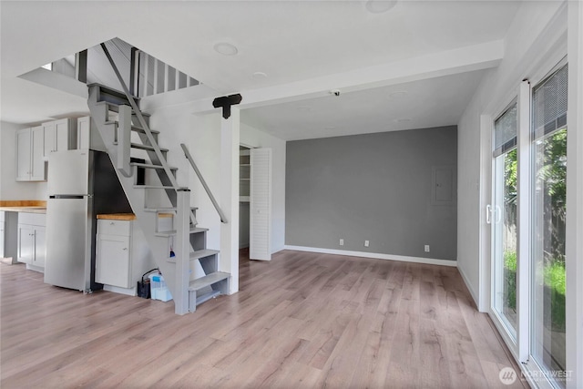 4050 E B St, Tacoma, WA 98404 - unfurnished living room with stairway and light wood-style flooring