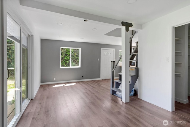 4050 E B St, Tacoma, WA 98404 - unfurnished living room with plenty of natural light, stairway, and wood finished floors