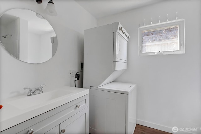 4050 E B St, Tacoma, WA 98404 - laundry area featuring stacked washer / drying machine and wood finished floors