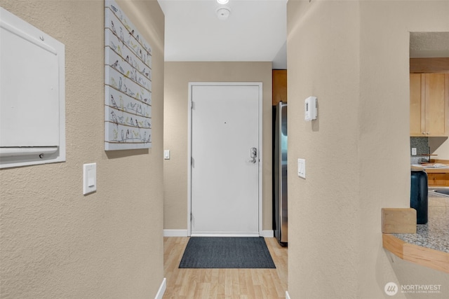 275 W Roy St Unit 319, Seattle, WA 98119 - entryway featuring light wood-style floors and a textured wall