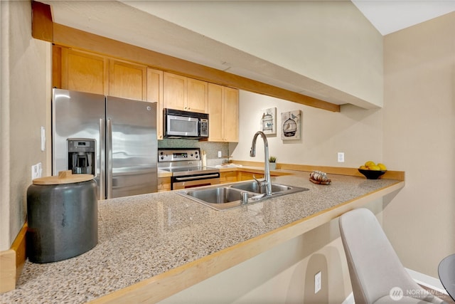 275 W Roy St Unit 319, Seattle, WA 98119 - kitchen with stainless steel appliances, light countertops, decorative backsplash, light brown cabinets, and a peninsula