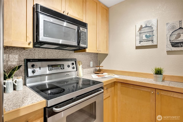 275 W Roy St Unit 319, Seattle, WA 98119 - kitchen featuring stainless steel electric stove, black microwave, light brown cabinets, and a textured wall