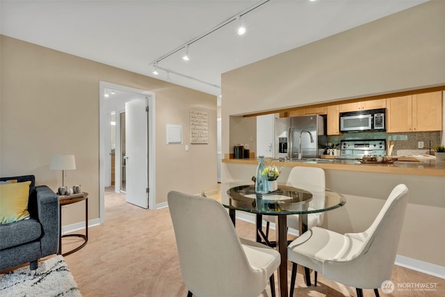 275 W Roy St Unit 319, Seattle, WA 98119 - dining area featuring track lighting and baseboards