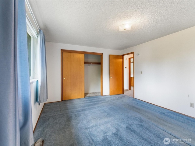 6702 120th St E, Puyallup, WA 98373 - unfurnished bedroom with a textured ceiling, carpet floors, and a closet