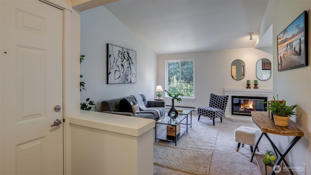 10619 SE 261st Pl Unit E303, Kent, WA 98030 - living room with a glass covered fireplace, lofted ceiling, a baseboard heating unit, and carpet