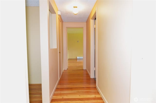 3428 99th Ave NE, Lake Stevens, WA 98258 - hall with light wood-style flooring and a baseboard heating unit