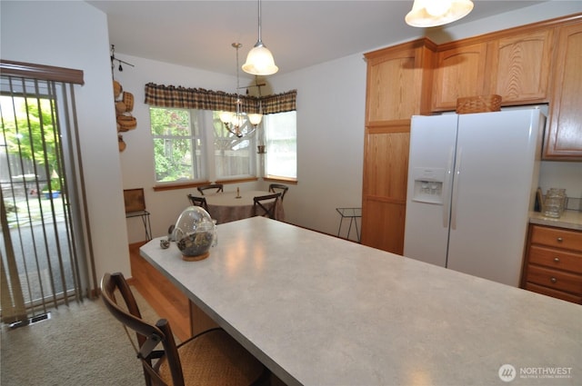 1750 Grand Ave, Mount Vernon, WA 98274 - kitchen with white refrigerator with ice dispenser, plenty of natural light, a chandelier, and light countertops