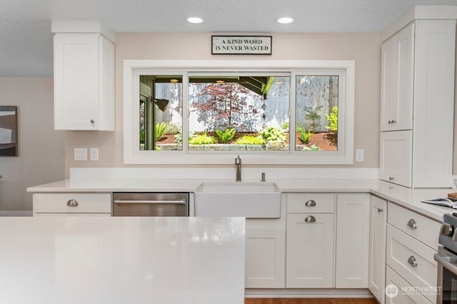 3200 SE Balboa Dr, Vancouver, WA 98683 - kitchen with dishwasher, white cabinetry, light countertops, recessed lighting, and a textured ceiling