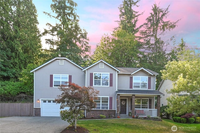 5304 114th St SE, Everett, WA 98208 - traditional home featuring covered porch, concrete driveway, a garage, and brick siding