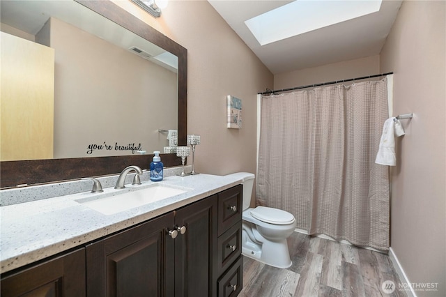 5304 114th St SE, Everett, WA 98208 - bathroom with wood finished floors, a skylight, vanity, and a shower with curtain