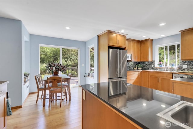 4623 224th St SE, Bothell, WA 98021 - kitchen with stainless steel appliances, plenty of natural light, decorative backsplash, light wood-style flooring, and recessed lighting