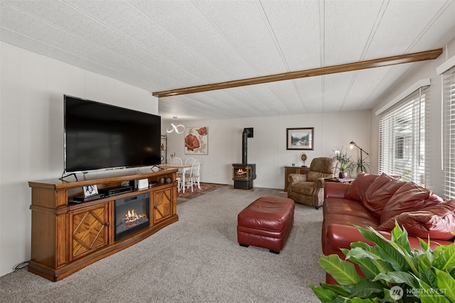 4707 Black Lake Belmore Rd SW Unit 50, Olympia, WA 98512 - living room with a wood stove, carpet floors, and wooden ceiling