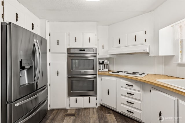 4707 Black Lake Belmore Rd SW Unit 50, Olympia, WA 98512 - kitchen with appliances with stainless steel finishes, under cabinet range hood, dark wood-type flooring, white cabinetry, and light countertops