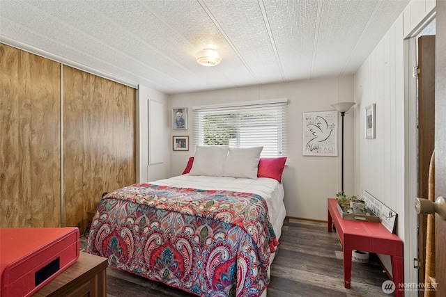 4707 Black Lake Belmore Rd SW Unit 50, Olympia, WA 98512 - bedroom with wood finished floors, a textured ceiling, and a closet