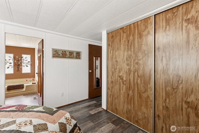 4707 Black Lake Belmore Rd SW Unit 50, Olympia, WA 98512 - bedroom featuring dark wood-style floors, ornamental molding, a closet, and ensuite bathroom