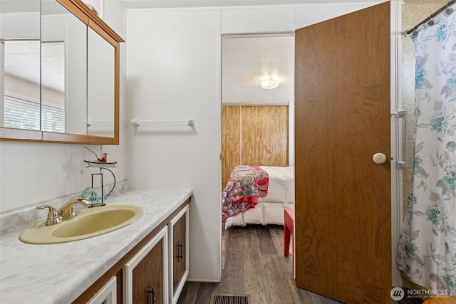 4707 Black Lake Belmore Rd SW Unit 50, Olympia, WA 98512 - full bath with vanity, wood finished floors, and curtained shower