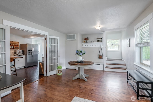 614 16th St SW, Puyallup, WA 98371 - dining room with a textured ceiling, stairs, french doors, and wood finished floors