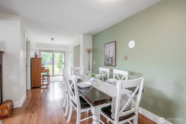 614 16th St SW, Puyallup, WA 98371 - dining area with baseboards and wood finished floors