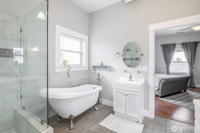 614 16th St SW, Puyallup, WA 98371 - ensuite bathroom with a freestanding bath, vanity, tiled shower, and tile walls