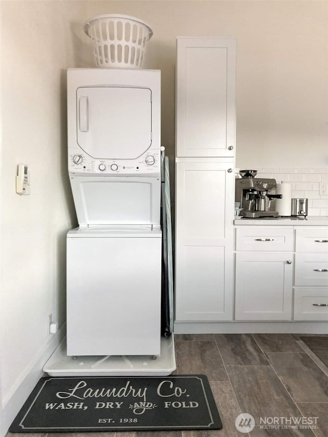 614 16th St SW, Puyallup, WA 98371 - laundry area with stacked washing machine and dryer and dark wood-type flooring