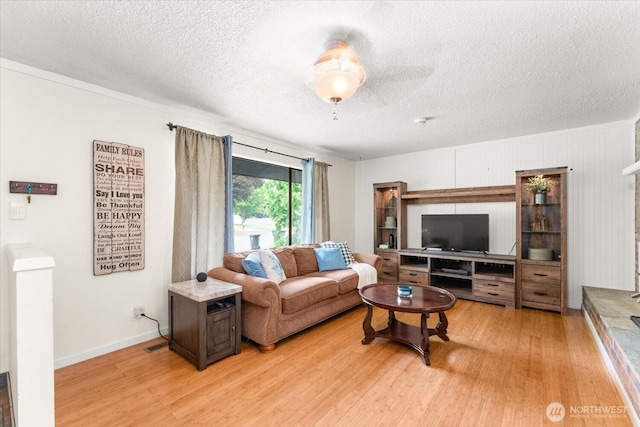 707 Kenwood St N, Omak, WA 98841 - living area with light wood-style flooring and a textured ceiling
