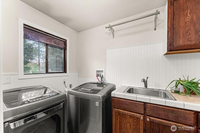 707 Kenwood St N, Omak, WA 98841 - washroom with washer and dryer, cabinet space, and a wainscoted wall